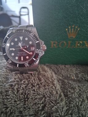 Rolex Stainless Steel Watch with Black Dial and Green Box Accent